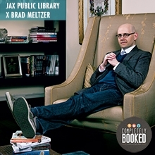 Brad Meltzer sitting in a chair with his feet up
