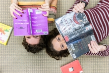 Jenna and Hurley hiding their faces behind books