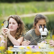 kids with a magnifying glass and microscope