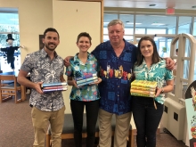 Bryan, Hurley and Jenna holding Tim Dorsey's books while posing with author Tim Dorsey