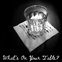 What's on your table? The photo, by Mary Atwood, shows a small drinking glass atop a napkin with writing on it.