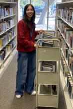Photo of smiling teen volunteer at the library.