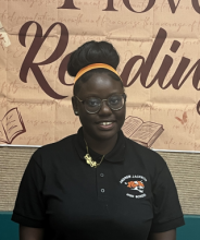 Teen John'Neisia smiles while volunteering at the Library.