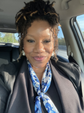 Photo of smiling library volunteer.