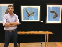 Michael Cenci standing in front of his nature photography