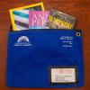 books in the library's blue Books by Mail pouch ready for mailing
