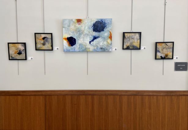 Several of Susan Smith's paintings on exhibit in the library