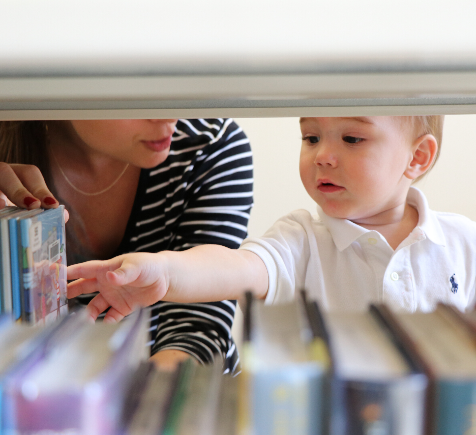 toddler reaching for a book