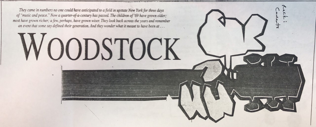 Woodstock newspaper image, guitar neck showing fingers playing with a perched bird on top